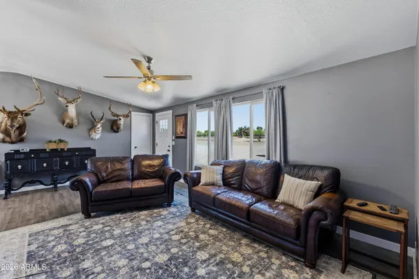a living room with furniture a ceiling fan and a rug