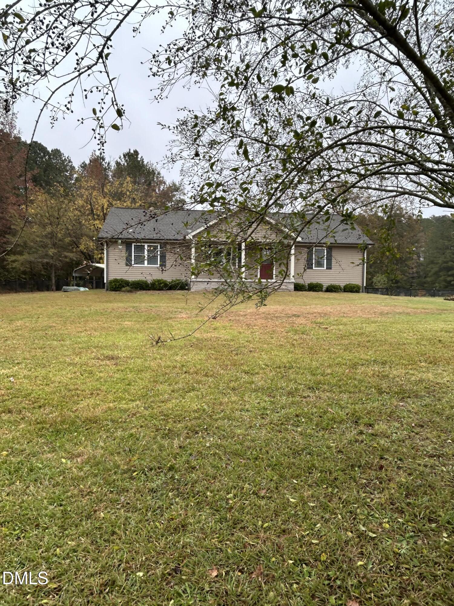 3105 Tump Wilkins Road Stem, NC 27581 - Photo 1 of 30 a front view of house with yard and trees around
