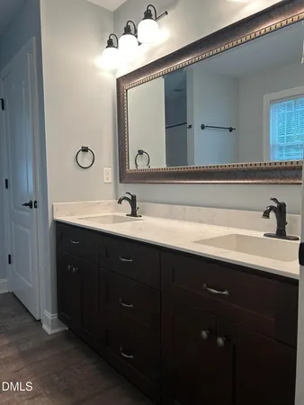 a bathroom with a double vanity sink and a mirror