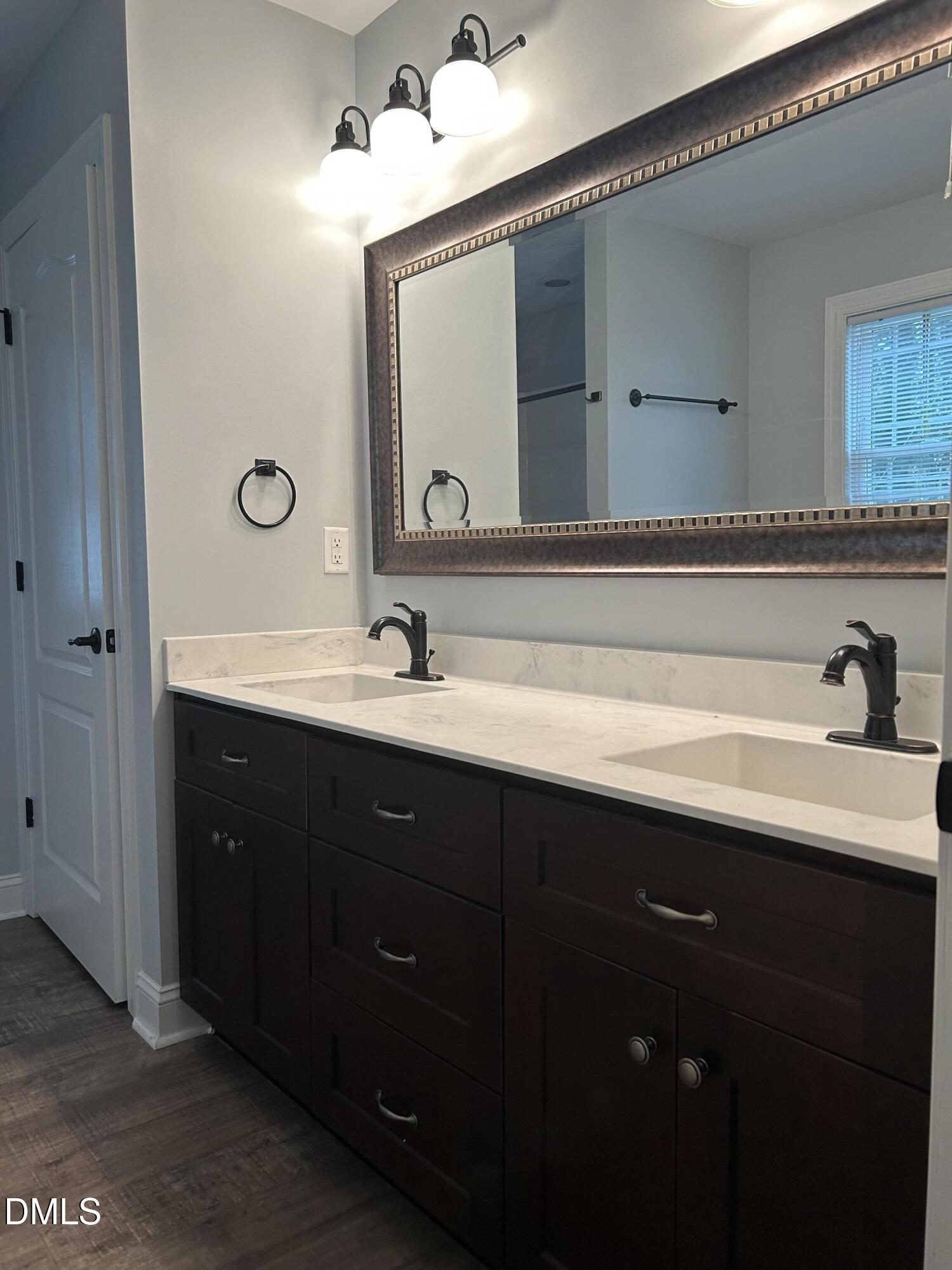 3105 Tump Wilkins Road Stem, NC 27581 - Photo 14 of 30 a bathroom with a double vanity sink and a mirror