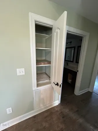 a view of walk in closet with empty racks