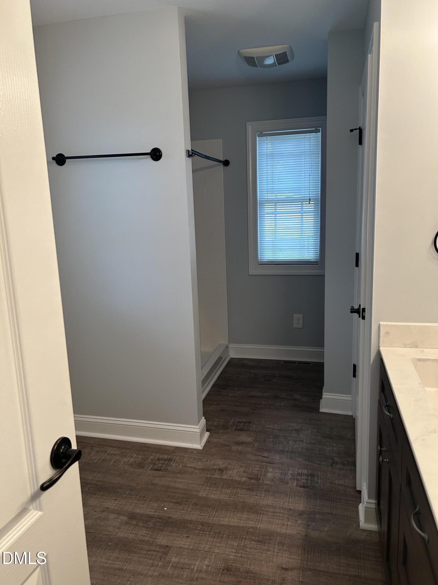 3105 Tump Wilkins Road Stem, NC 27581 - Photo 19 of 30 a view of an empty room with wooden floor and a window