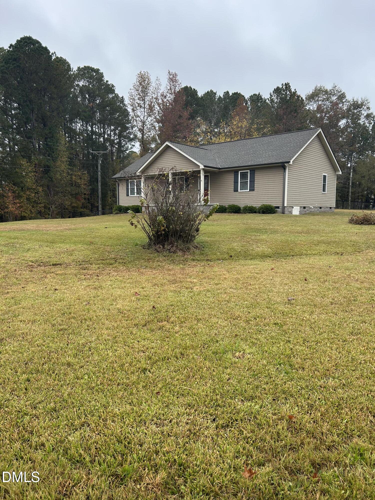 3105 Tump Wilkins Road Stem, NC 27581 - Photo 2 of 30 a front view of a house with a yard