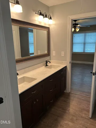 a bathroom with a double vanity sink and a mirror
