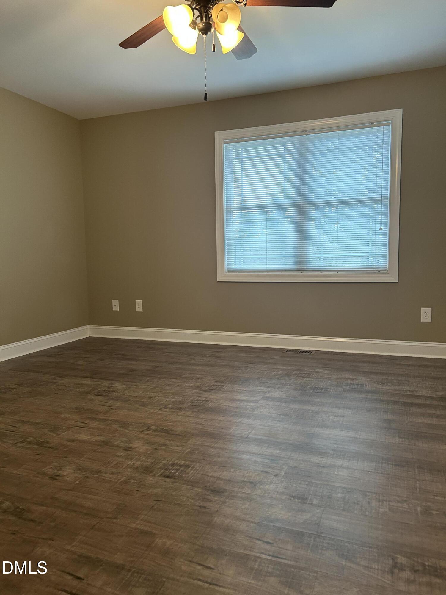 3105 Tump Wilkins Road Stem, NC 27581 - Photo 24 of 30 a view of an empty room with wooden floor and a window