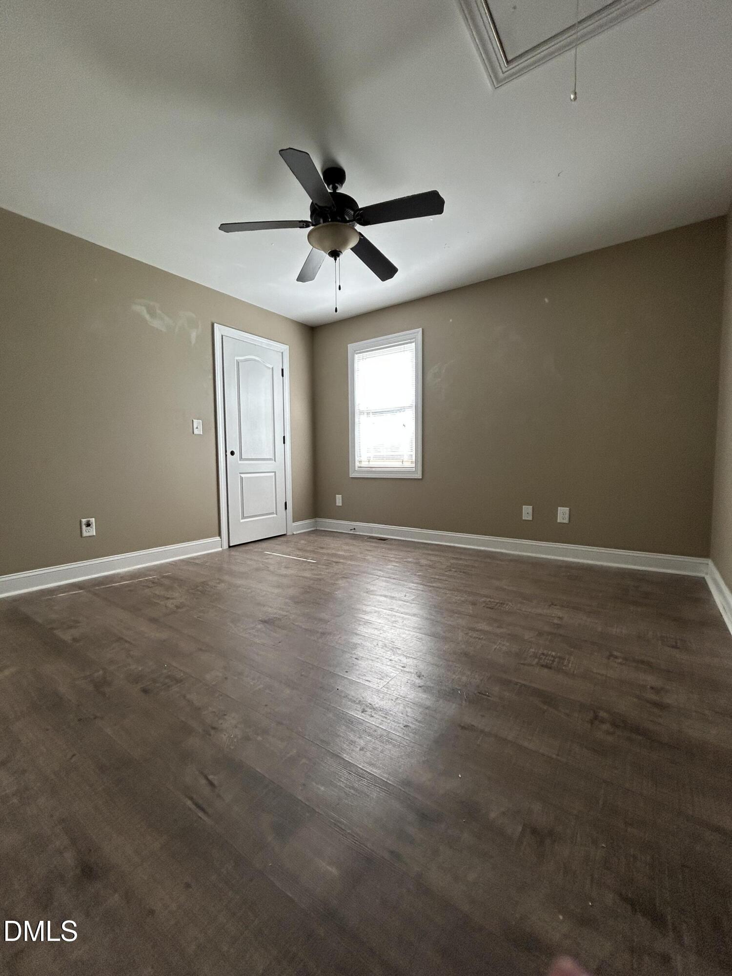 3105 Tump Wilkins Road Stem, NC 27581 - Photo 25 of 30 an empty room with wooden floor and windows