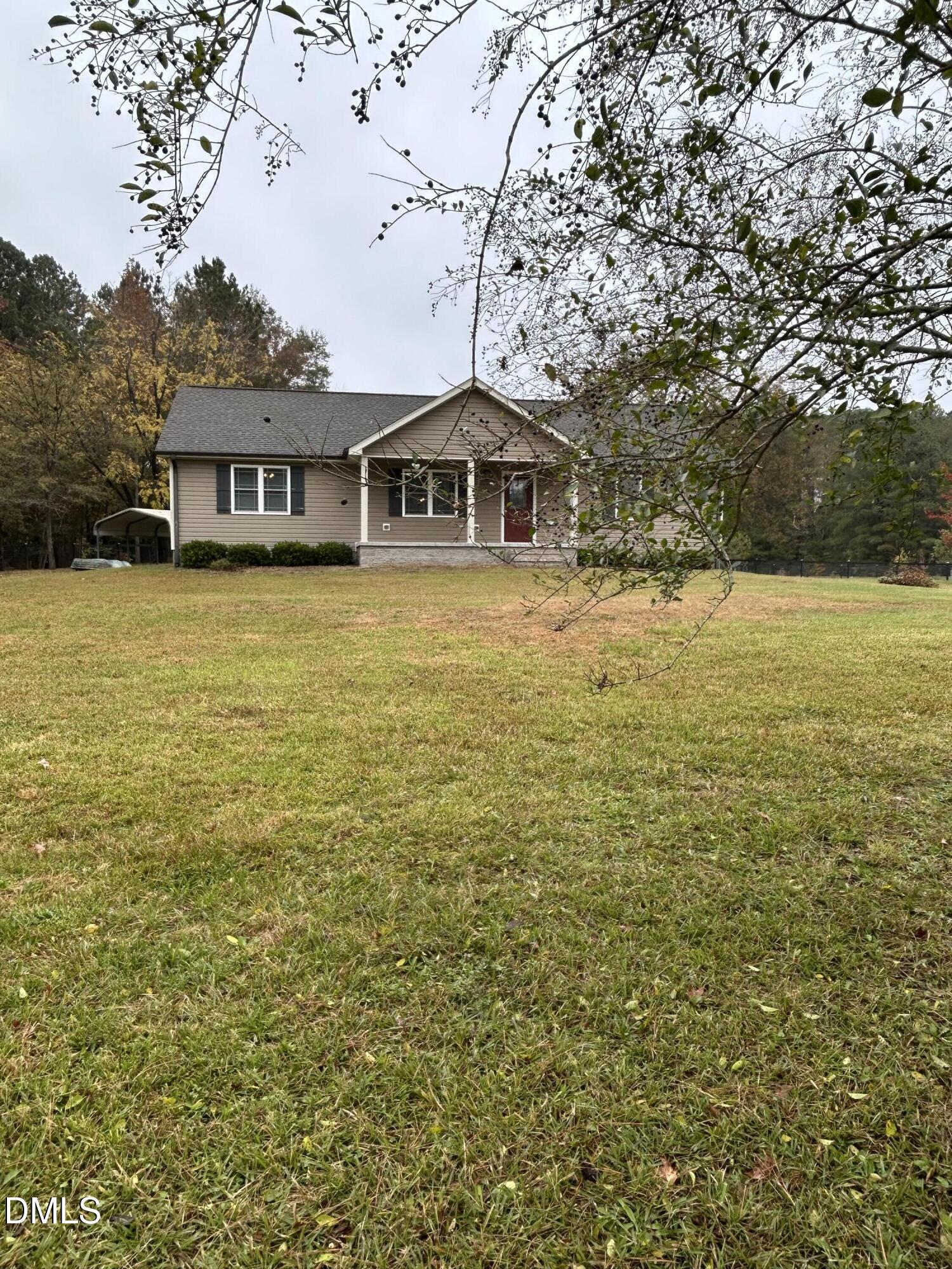3105 Tump Wilkins Road Stem, NC 27581 - Photo 28 of 30 a front view of a house with a yard