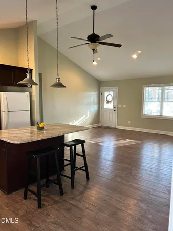 a view of a livingroom with furniture window and wooden floor