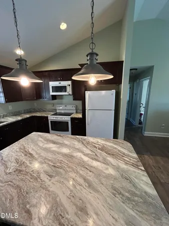 a kitchen with a stove and refrigerator