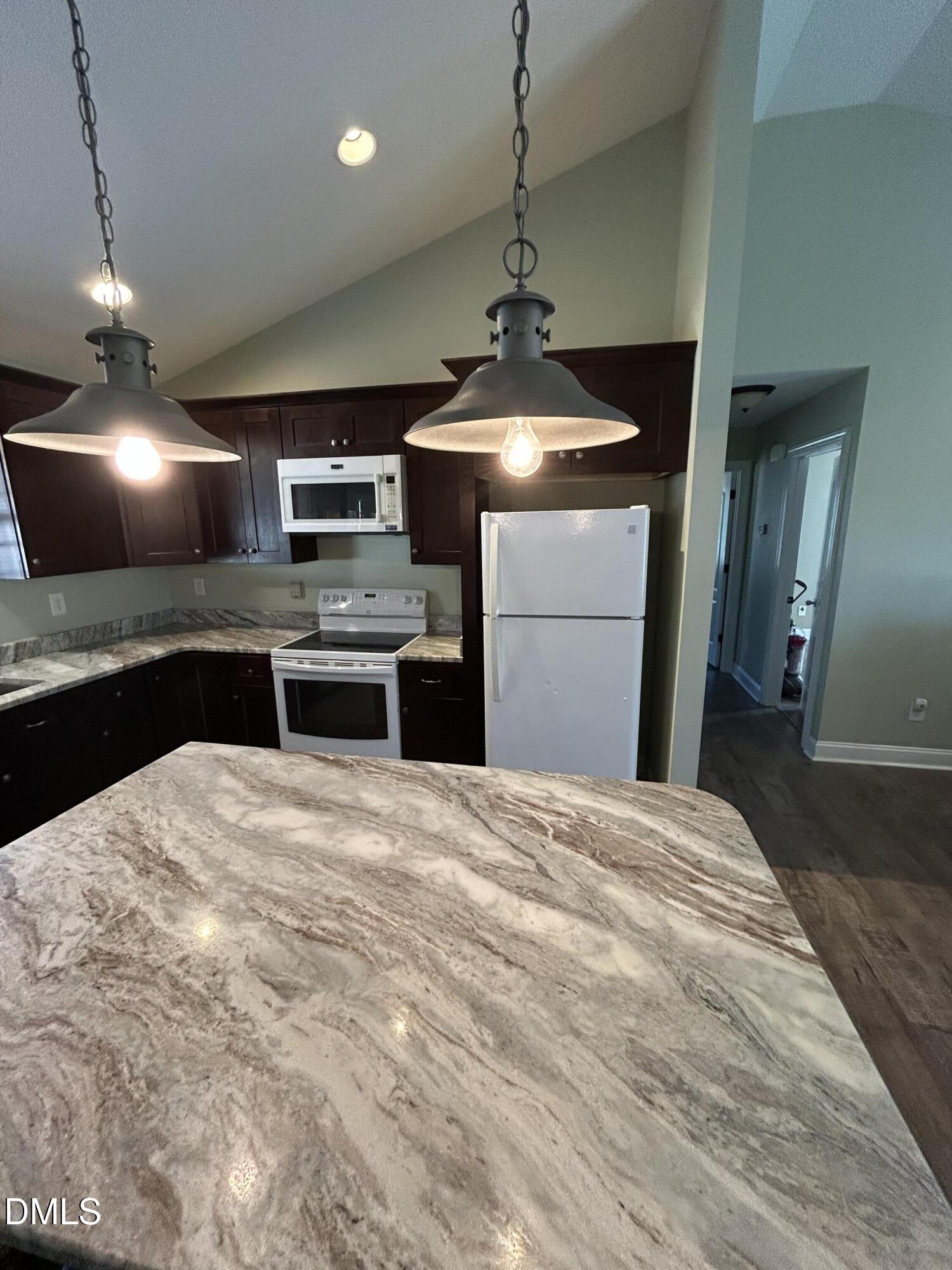 3105 Tump Wilkins Road Stem, NC 27581 - Photo 8 of 30 a kitchen with a stove and refrigerator