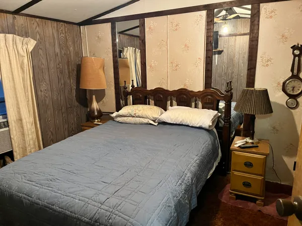 a bedroom with a bed and a mirror