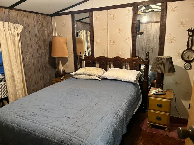 a bedroom with a bed and a mirror