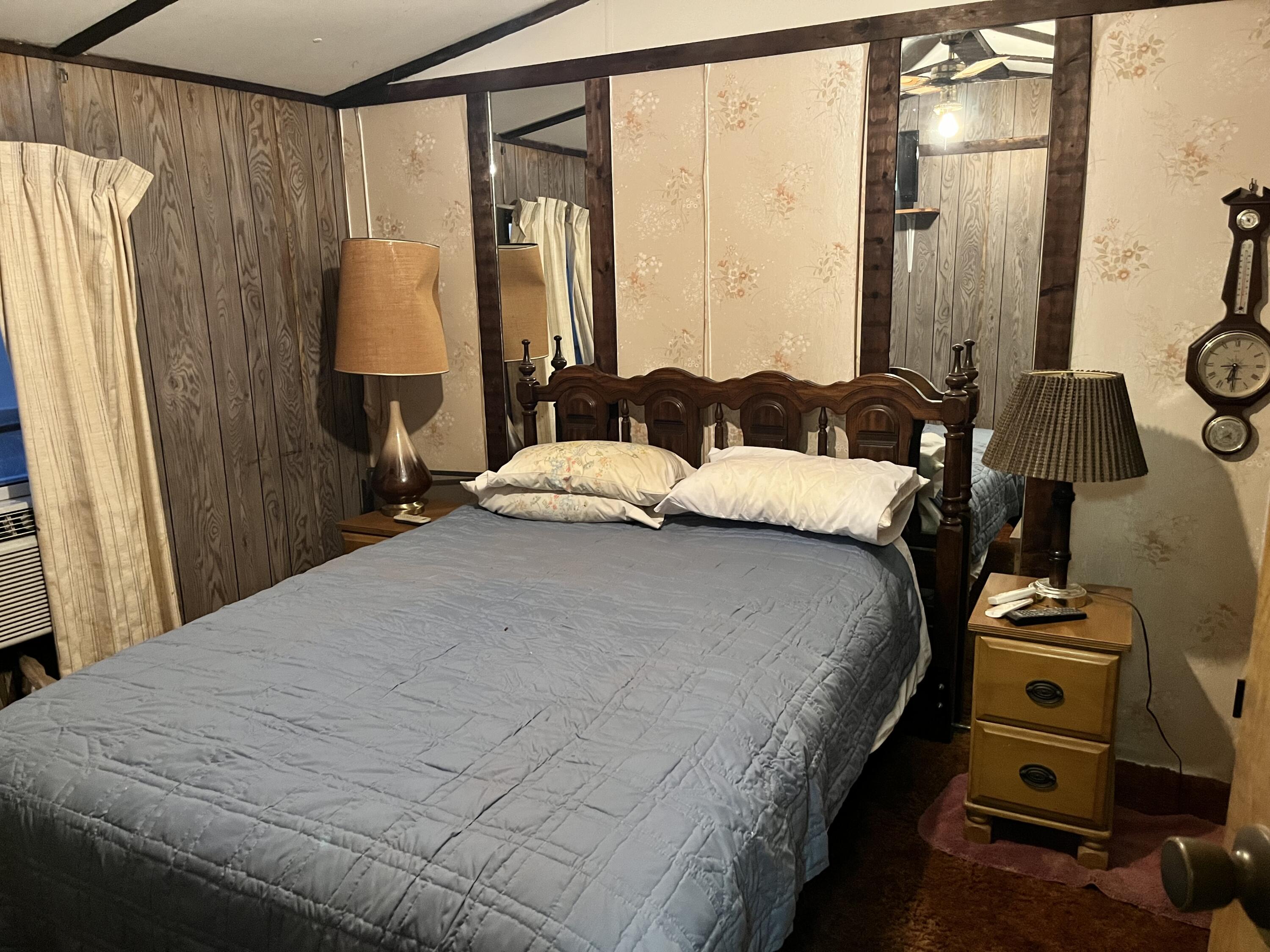 329 Spur Road Spur, TX 79370 - Photo 14 of 17 a bedroom with a bed and a mirror