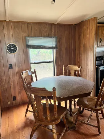 a dining room with furniture and window
