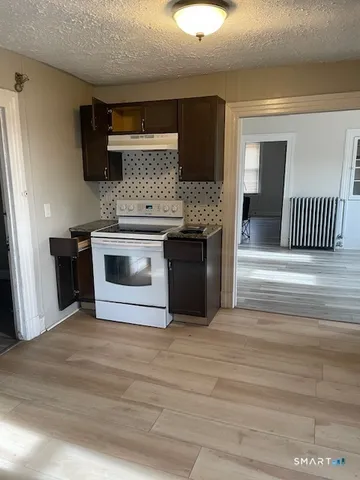 a kitchen with stainless steel appliances granite countertop a stove and a sink