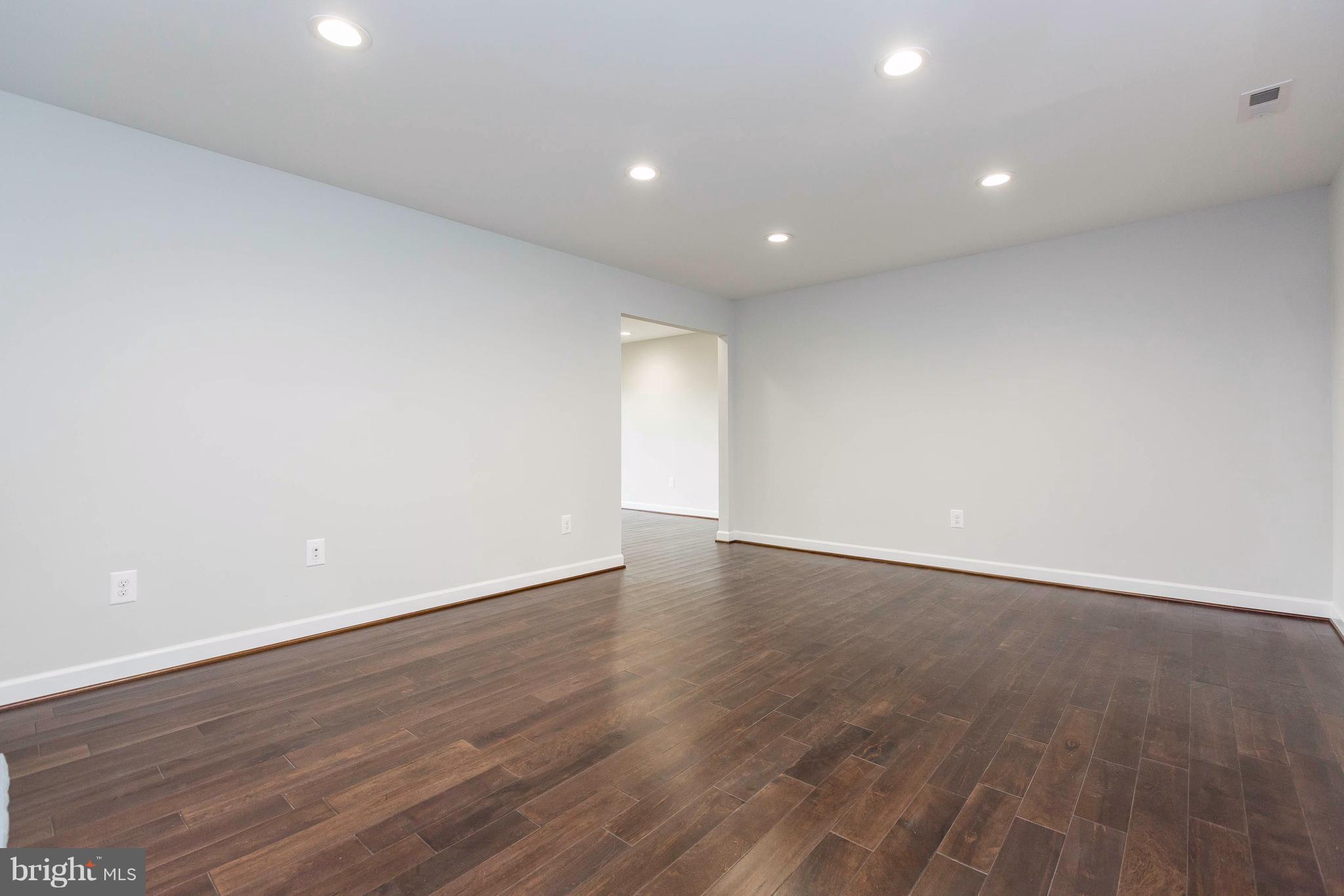 23435 Peach Tree Road Clarksburg, MD 20871 - Photo 2 of 26 an empty room with wooden floor and natural light
