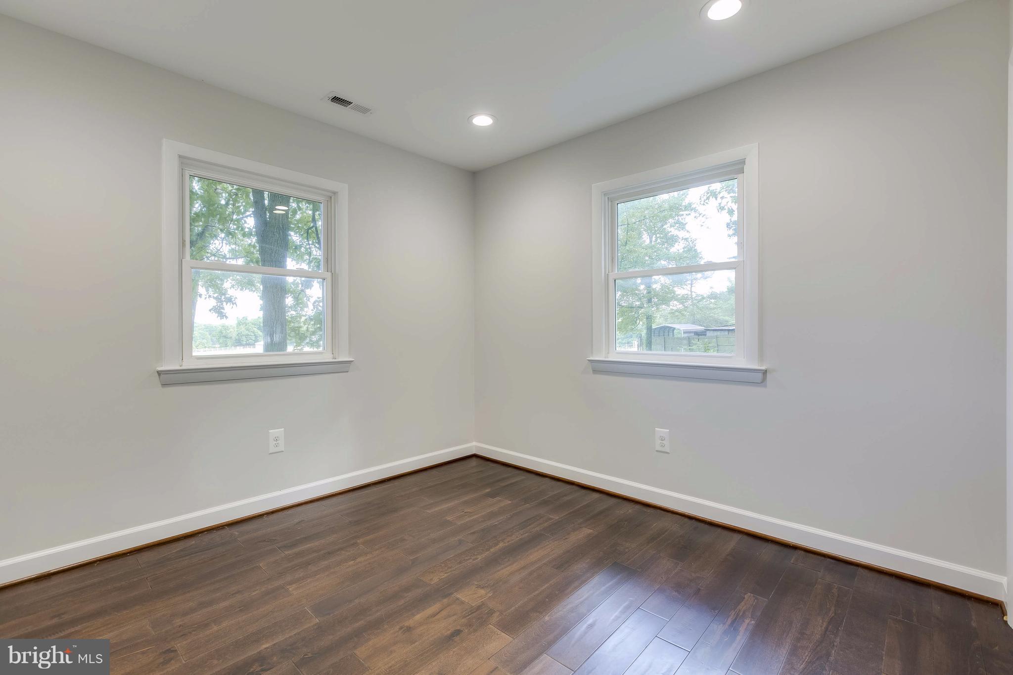 23435 Peach Tree Road Clarksburg, MD 20871 - Photo 12 of 26 a view of a big room with wooden floor and windows in it