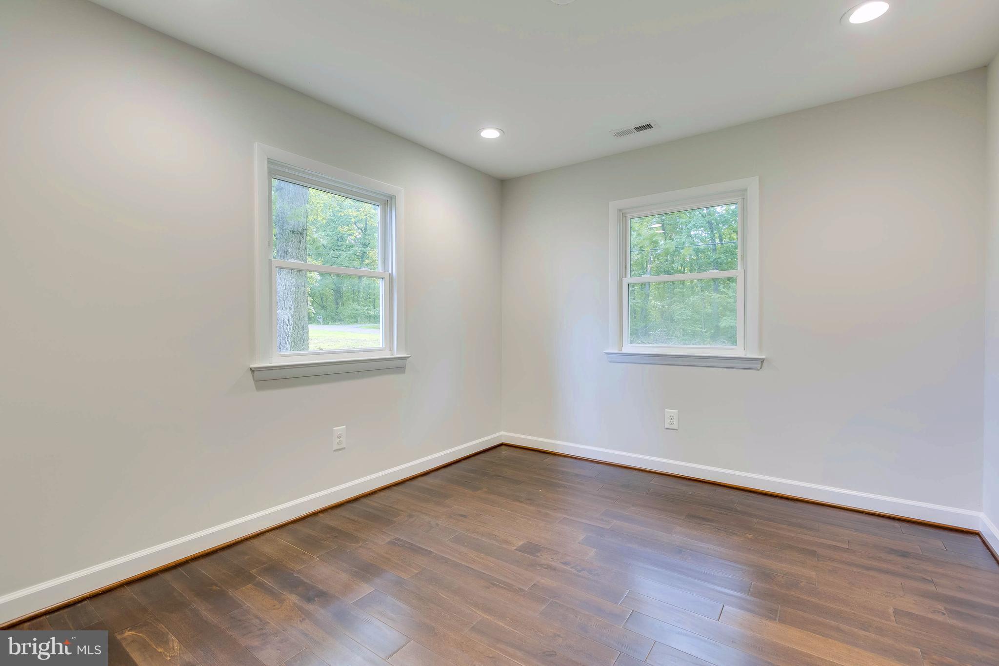 23435 Peach Tree Road Clarksburg, MD 20871 - Photo 13 of 26 an empty room with wooden floor and windows