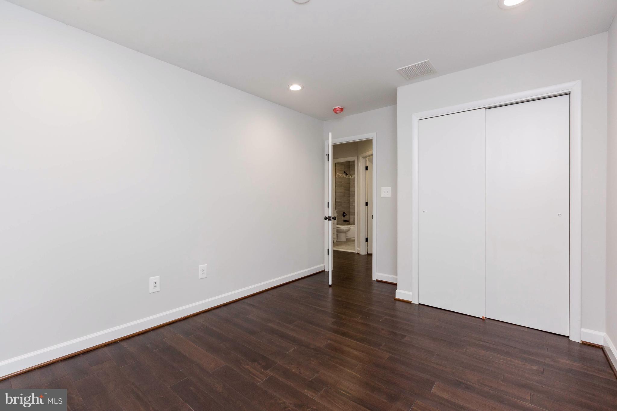 23435 Peach Tree Road Clarksburg, MD 20871 - Photo 14 of 26 a view of an empty room with wooden floor and closet