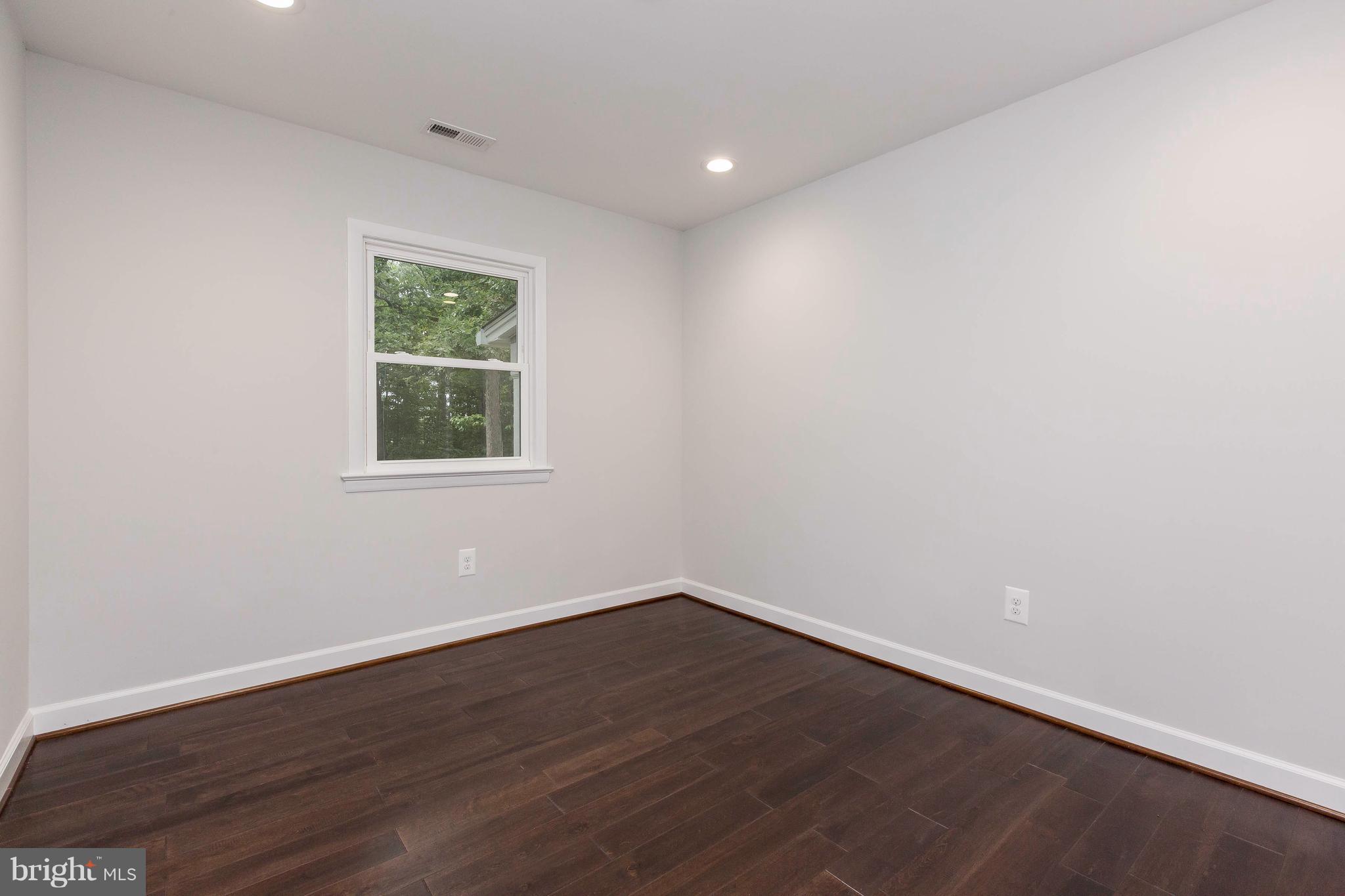 23435 Peach Tree Road Clarksburg, MD 20871 - Photo 15 of 26 a view of an empty room with wooden floor and a window