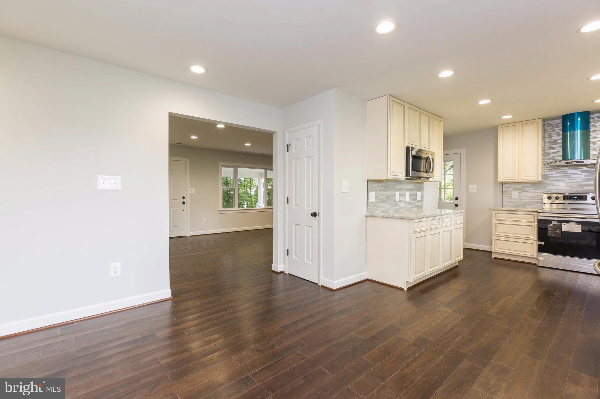 23435 Peach Tree Road Clarksburg, MD 20871 - Photo 5 of 26 a view of a kitchen with wooden floor and electronic appliances