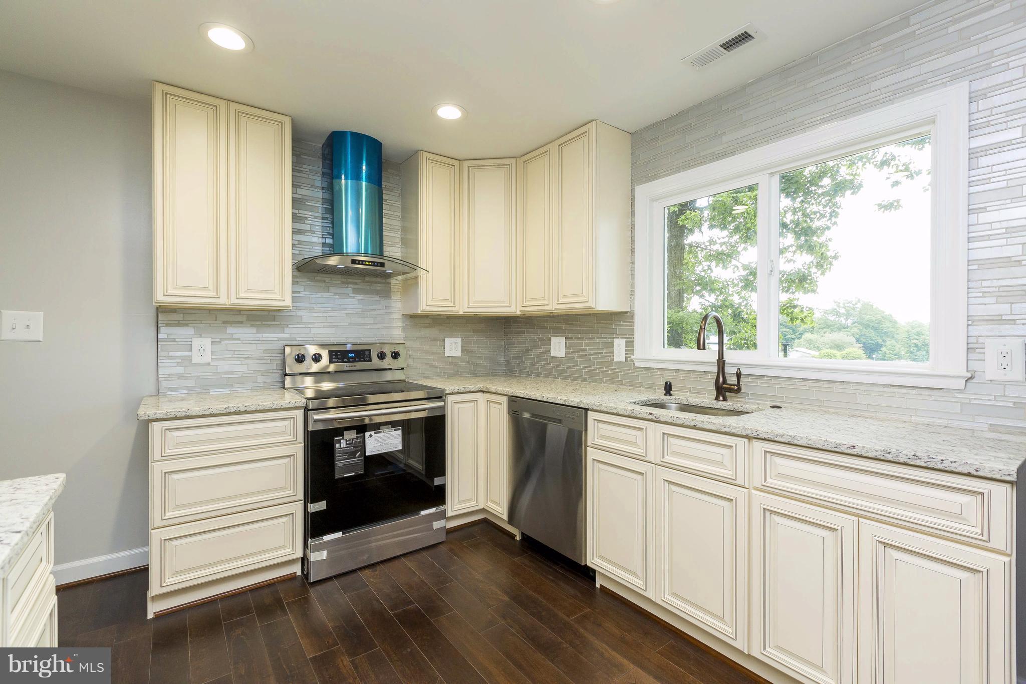 23435 Peach Tree Road Clarksburg, MD 20871 - Photo 6 of 26 a kitchen with stainless steel appliances white cabinets and a sink