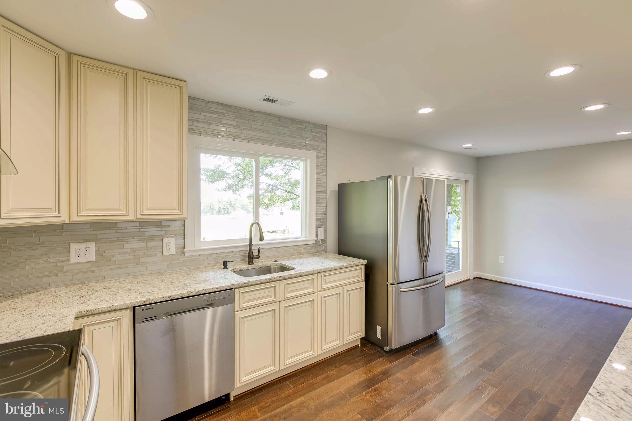 23435 Peach Tree Road Clarksburg, MD 20871 - Photo 9 of 26 a kitchen with a sink a refrigerator and window