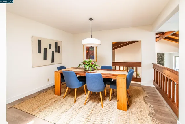 a dining room with furniture a rug and a chandelier