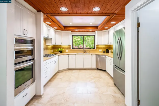 a kitchen with stainless steel appliances granite countertop a stove sink and cabinets