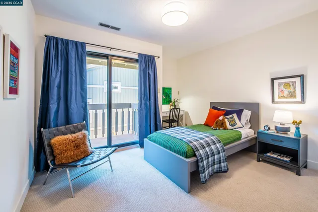 a bedroom with a bed and a chair