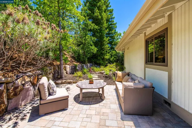 a view of a patio with couches and potted plants
