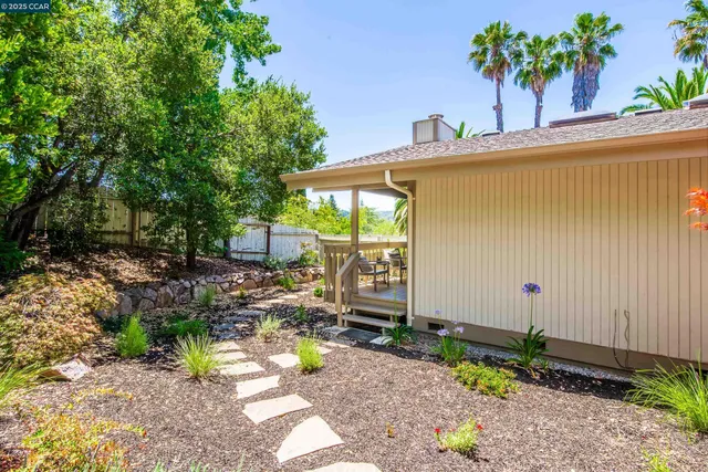 a view of deck with furniture and trees in the front