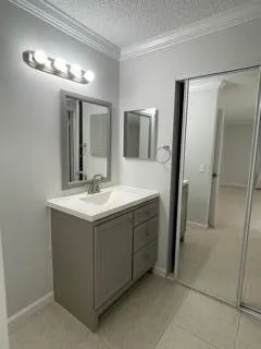 a bathroom with a double vanity sink and a mirror
