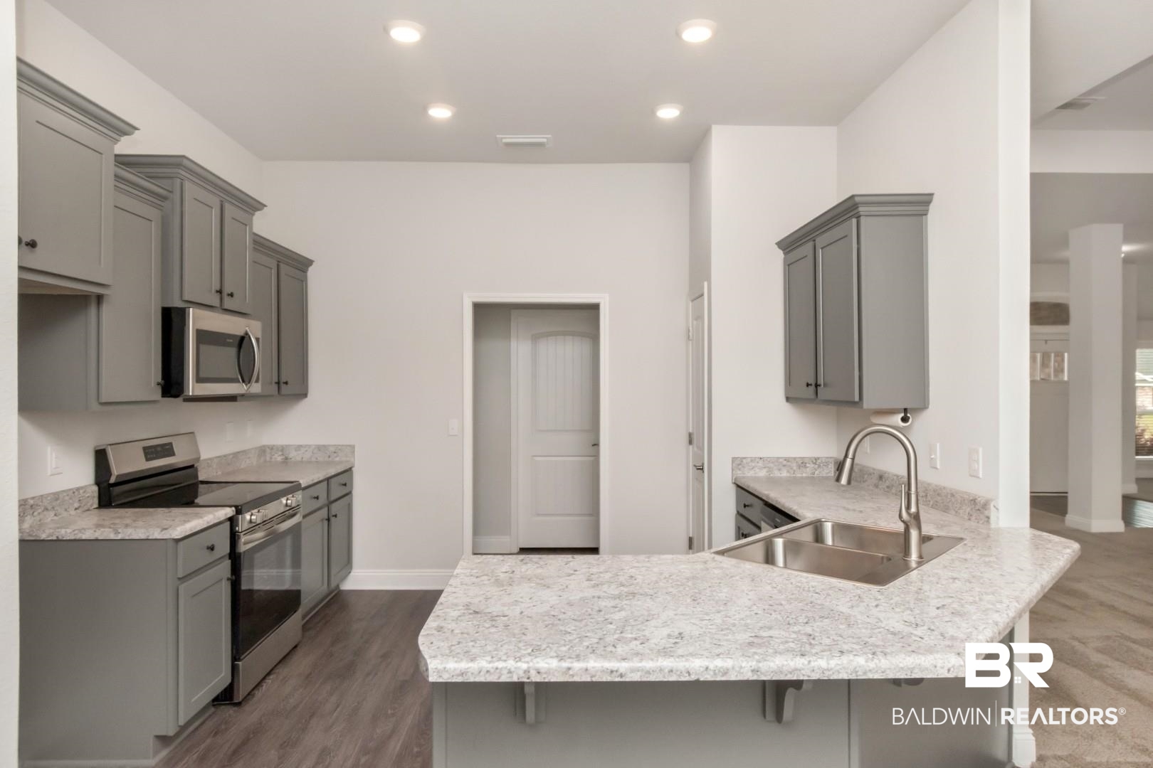 6632 Monarch Circle Mobile, AL 36618 - Photo 10 of 32 Kitchen featuring stainless steel appliances, a peninsula, gray cabinetry, a breakfast bar area, and recessed lighting