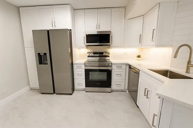 a kitchen with a stove sink and refrigerator