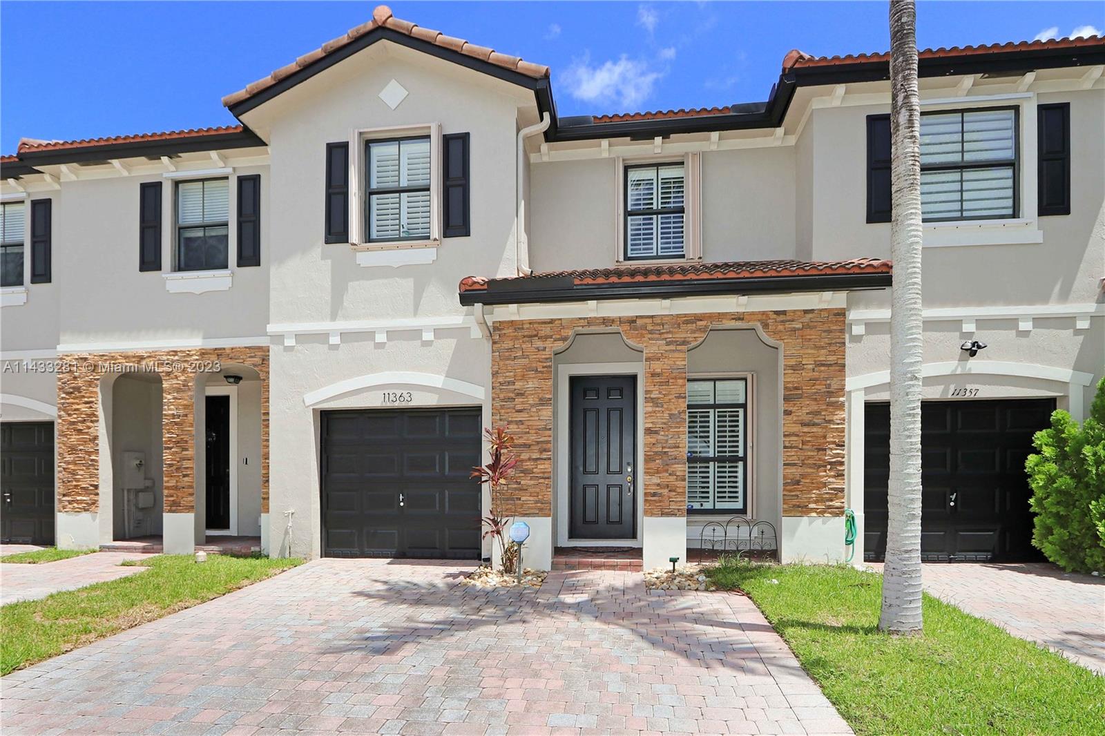 11363 Southwest 240th Street Homestead, FL 33032 - Photo 1 of 39 a front view of a house with yard and parking