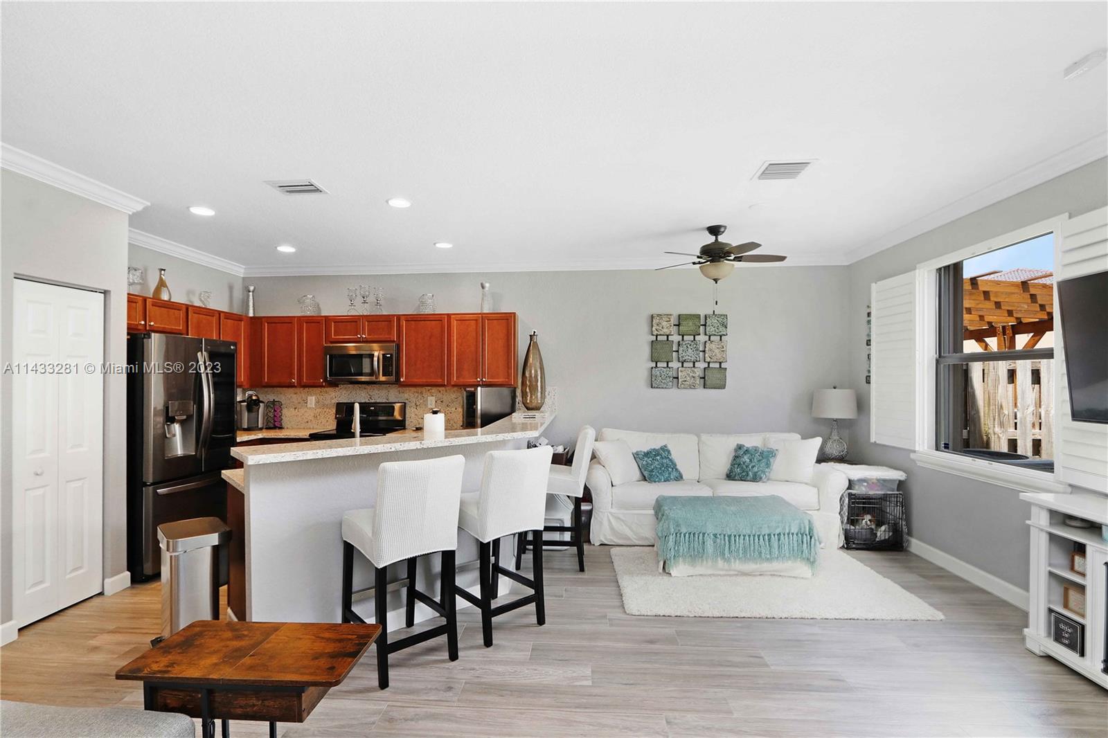 11363 Southwest 240th Street Homestead, FL 33032 - Photo 11 of 39 a living room with lots of furniture and kitchen view