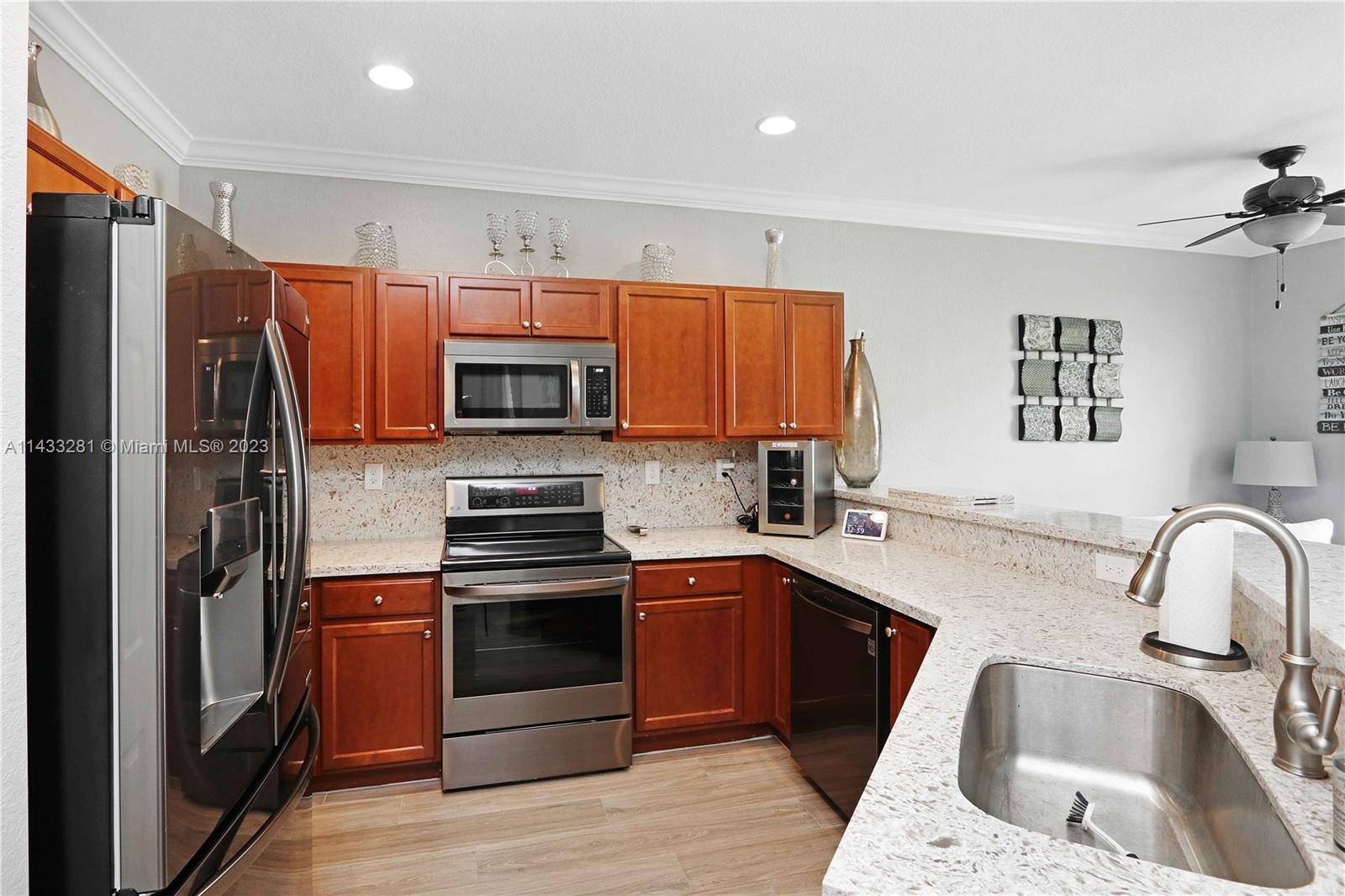 11363 Southwest 240th Street Homestead, FL 33032 - Photo 12 of 39 a kitchen with stainless steel appliances granite countertop a sink stove and refrigerator