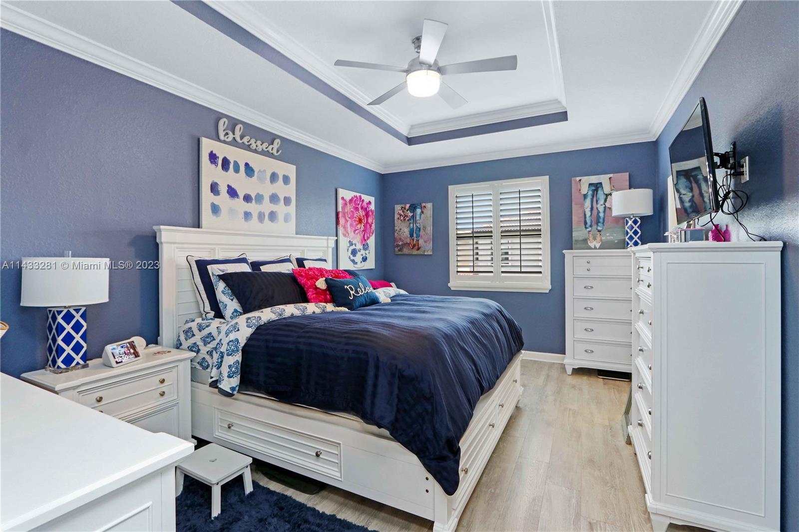 11363 Southwest 240th Street Homestead, FL 33032 - Photo 15 of 39 a bedroom with a bed and a chandelier