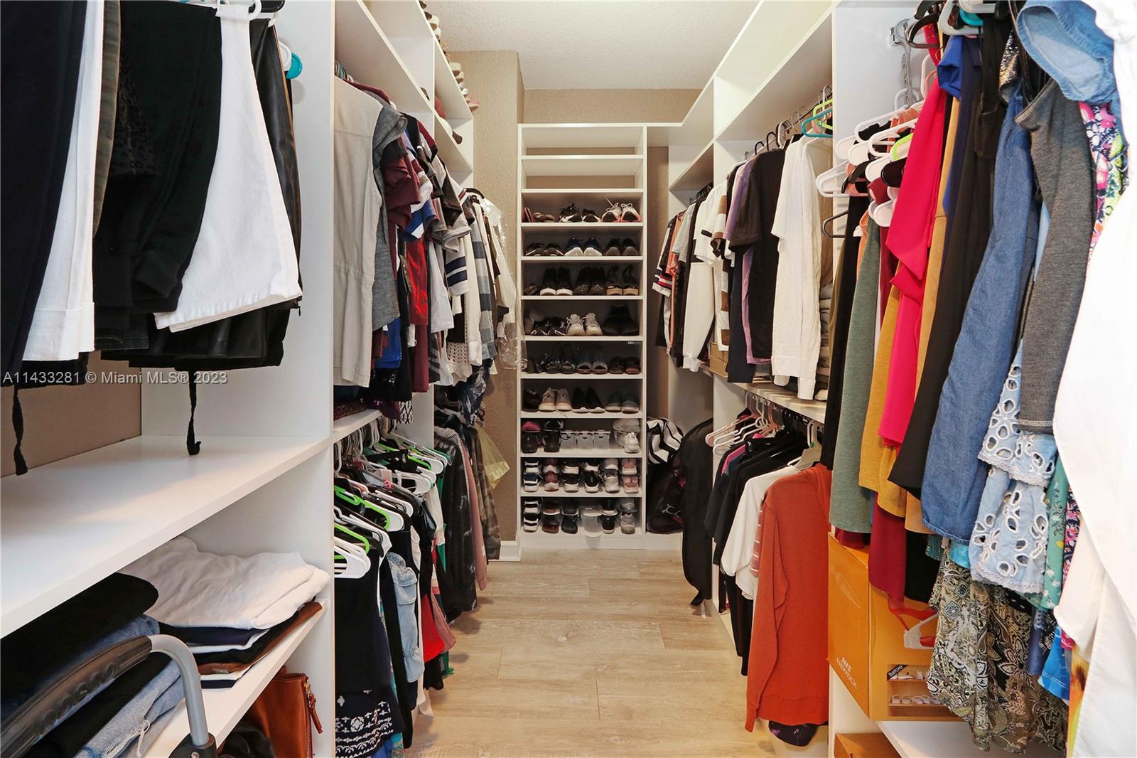 11363 Southwest 240th Street Homestead, FL 33032 - Photo 18 of 39 a view of walk in closet with clothes