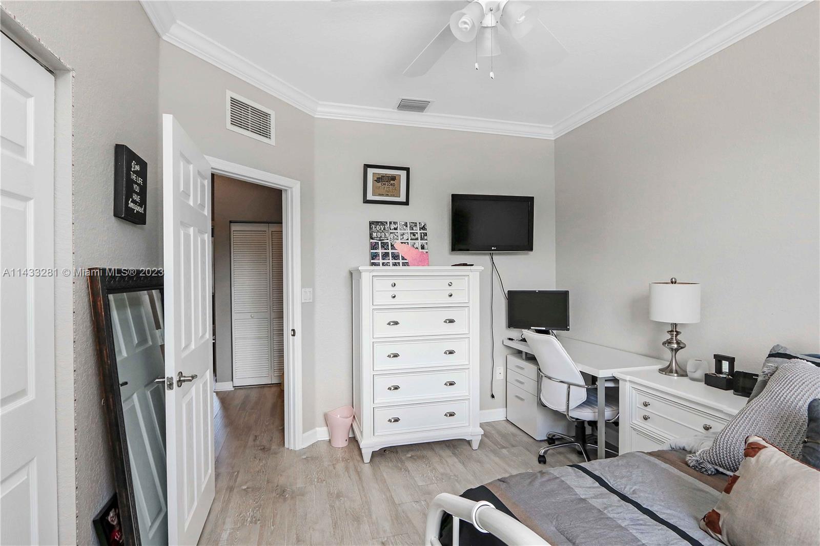 11363 Southwest 240th Street Homestead, FL 33032 - Photo 22 of 39 a view of a workspace with furniture and a flat screen tv
