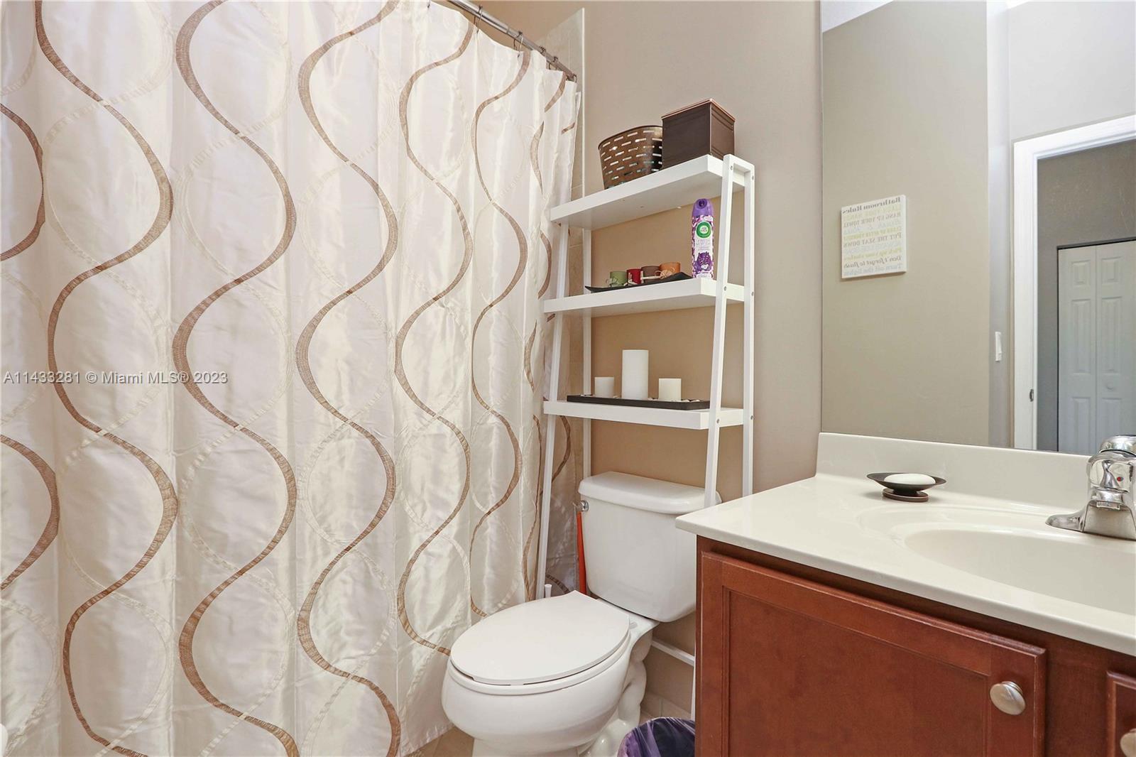 11363 Southwest 240th Street Homestead, FL 33032 - Photo 23 of 39 a bathroom with a sink vanity mirror and toilet