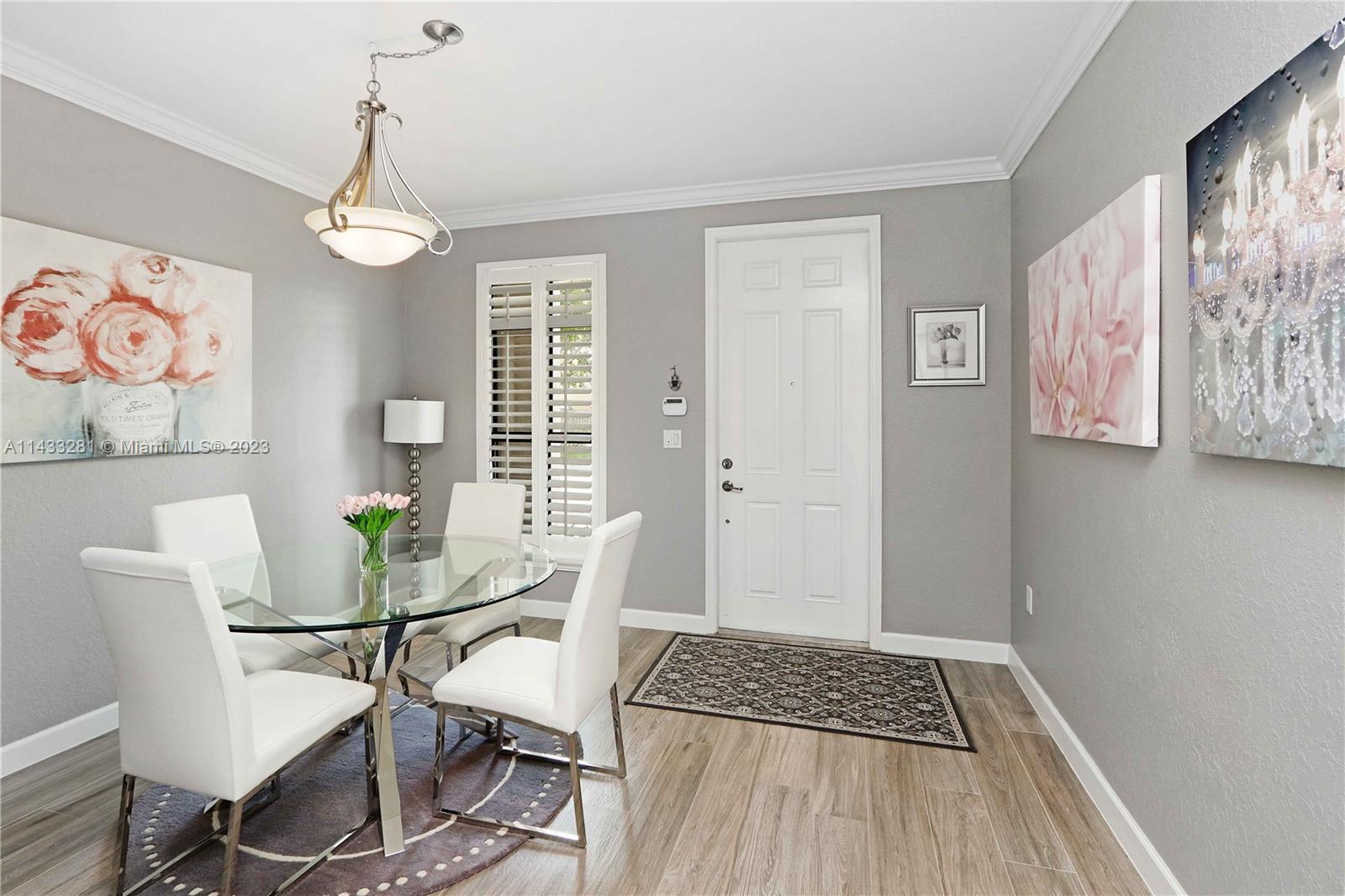 11363 Southwest 240th Street Homestead, FL 33032 - Photo 6 of 39 a view of a dining room with furniture window and wooden floor