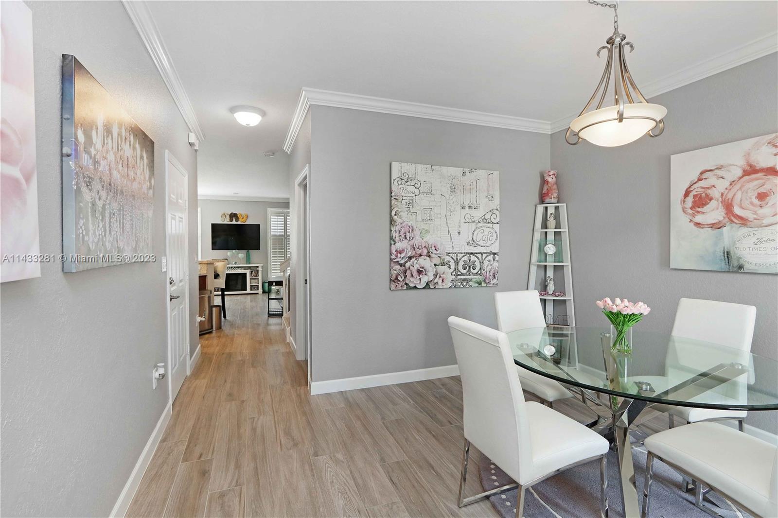 11363 Southwest 240th Street Homestead, FL 33032 - Photo 7 of 39 a view of a dining room with furniture and wooden floor