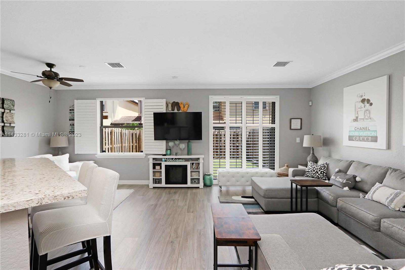11363 Southwest 240th Street Homestead, FL 33032 - Photo 8 of 39 a living room with furniture a fireplace and a flat screen tv