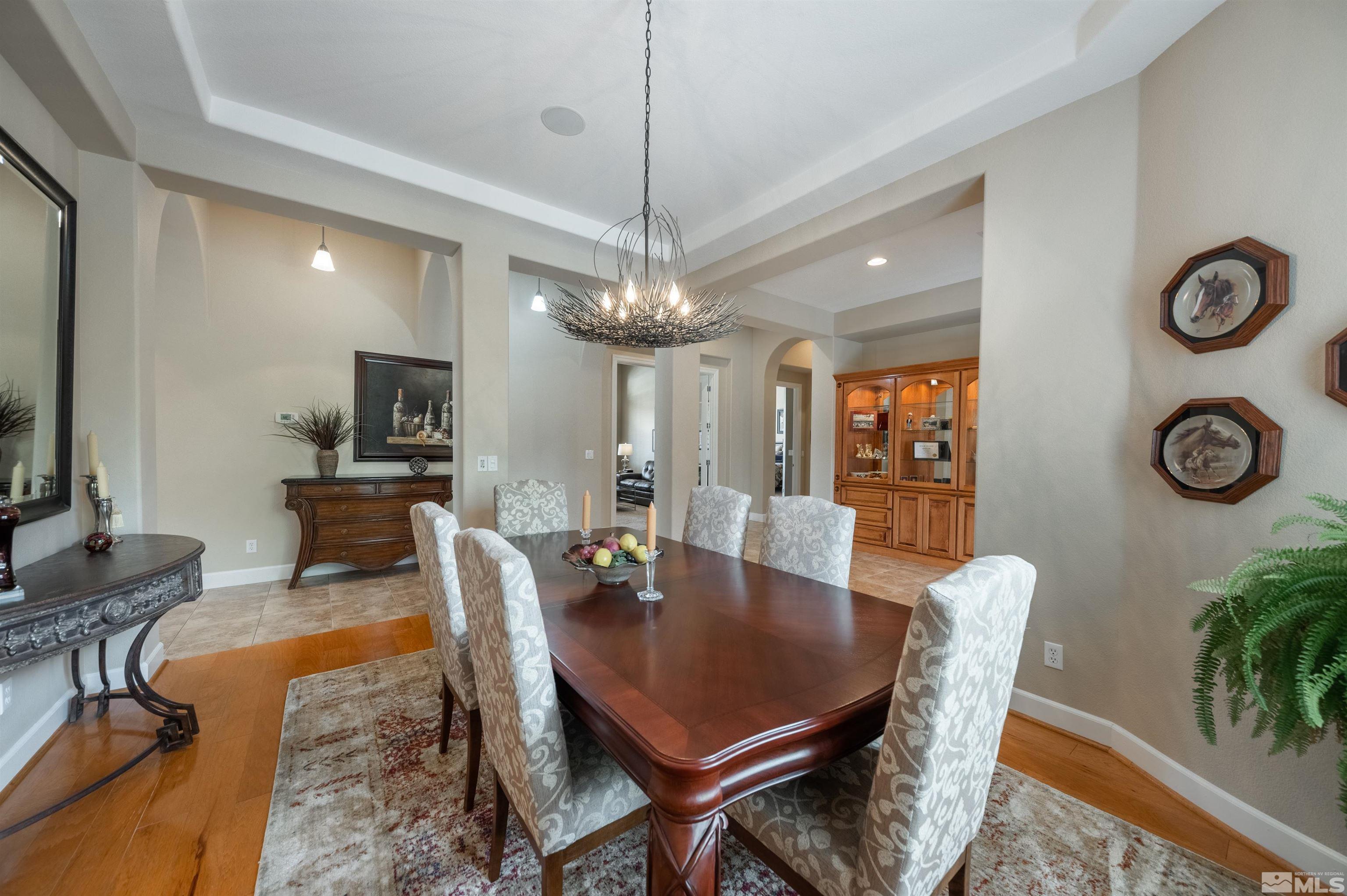 10150 Burghley Lane Reno, NV 89521 - Photo 16 of 40 a view of a dining room with furniture window and wooden floor