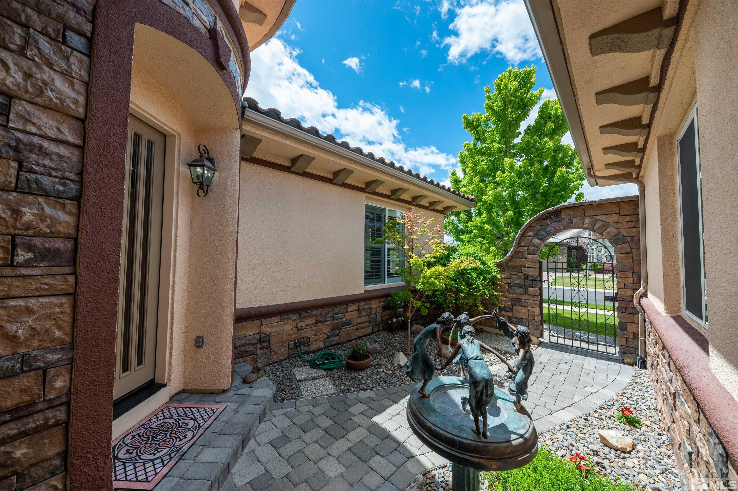 10150 Burghley Lane Reno, NV 89521 - Photo 3 of 40 a view of a porch with chairs and potted plants