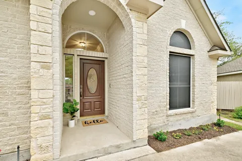 a view of a door of the house with a large windows
