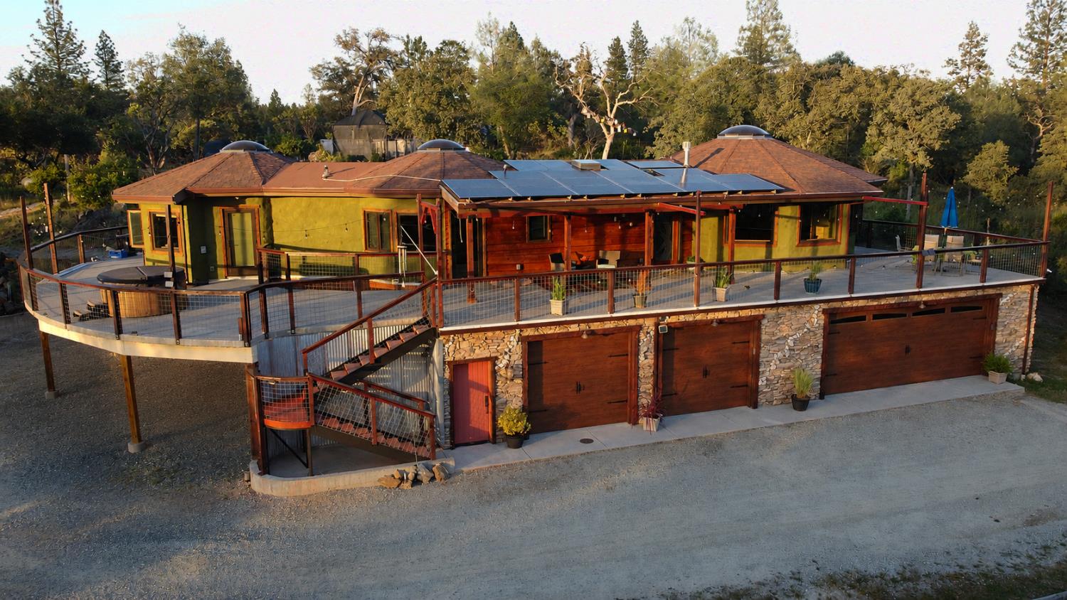 an aerial view of a house with swimming pool and sitting area
