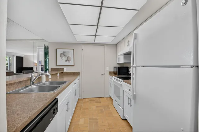 a kitchen that has a sink and a stove